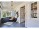 Bright sunroom with natural light, chair, rug, and white-painted walls and trim at 2252 S Lafayette St, Denver, CO 80210