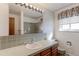 Bathroom featuring a large mirror, updated vanity, and decorative lighting, for a spa-like experience at 9202 W Virginia Pl, Lakewood, CO 80226