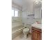 Bathroom featuring shower and tub combo with a neutral color scheme and updated fixtures at 9202 W Virginia Pl, Lakewood, CO 80226