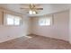 Bright bedroom with neutral walls, carpet, and natural light from two windows at 9202 W Virginia Pl, Lakewood, CO 80226