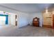 Spacious living room with neutral carpet, a piano, and open access to kitchen and entryway at 9202 W Virginia Pl, Lakewood, CO 80226