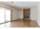 Open concept living room with brick fireplace, hardwood floors, and sliding glass doors to the backyard at 9202 W Virginia Pl, Lakewood, CO 80226