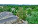 Cozy townhouse with attached garage nestled among lush greenery with a view of mountains in the distance at 8055 E Colorado Ave # 8, Denver, CO 80231