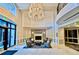Bright lobby with a fireplace, chandelier, comfortable seating area, and floor to ceiling windows at 1827 N Grant St # 1104, Denver, CO 80203
