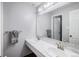 Bathroom featuring dual sinks, a large mirror, and neutral tones at 92 Helena Cir, Littleton, CO 80124