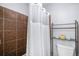 Bathroom with a tiled shower and storage shelves at 92 Helena Cir, Littleton, CO 80124