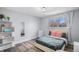 Bedroom featuring wood floors, a built in shelf, and neutral colored walls at 92 Helena Cir, Littleton, CO 80124