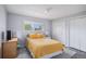 Bright bedroom with yellow bedding, a window, and wood-look vinyl flooring at 92 Helena Cir, Littleton, CO 80124