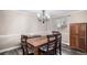 Traditional dining room with a wood table, matching chairs, and a decorative chandelier at 92 Helena Cir, Littleton, CO 80124