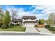 Traditional two-story home featuring a well-maintained lawn, attached garage, and charming curb appeal at 92 Helena Cir, Littleton, CO 80124