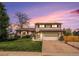 Charming two-story home with a well-maintained lawn and attached two-car garage at 92 Helena Cir, Littleton, CO 80124