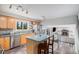 Bright kitchen featuring stainless steel appliances, a center island, and a view into the living room at 92 Helena Cir, Littleton, CO 80124