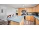 Well-lit kitchen with a center island, stainless steel appliances, and a convenient breakfast bar at 92 Helena Cir, Littleton, CO 80124
