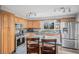 Well-lit kitchen featuring stainless steel appliances, modern fixtures, and ample counter space at 92 Helena Cir, Littleton, CO 80124