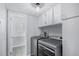 Clean laundry room with washer, dryer, and white storage cabinets at 92 Helena Cir, Littleton, CO 80124