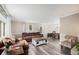 Inviting living room featuring a leather sofa, decorative coffee table, and elegant crown molding at 92 Helena Cir, Littleton, CO 80124