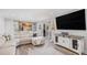 Open living room with hardwood floors, walkout, and media center at 92 Helena Cir, Littleton, CO 80124