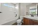 Bathroom with a shower over bath with white tile, a light wood vanity, and neutral wall paint at 19782 W 59Th Ave, Golden, CO 80403