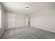Bedroom with neutral colored walls and carpet with two doors and a window at 19782 W 59Th Ave, Golden, CO 80403