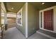Cozy covered porch with stone accents and a classic red front door at 19782 W 59Th Ave, Golden, CO 80403