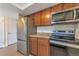 Kitchen featuring stainless steel appliances and dark brown cabinets at 4866 S Dudley St # 9, Littleton, CO 80123