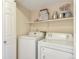 Laundry room with white washer, dryer, and ample shelf storage at 4866 S Dudley St # 9, Littleton, CO 80123