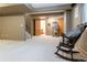 Spacious finished basement with chair and stairs at 12222 N Ivanhoe Cir, Brighton, CO 80602