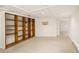 View of the finished basement featuring carpet, white trim, and a large wooden bookcase at 1615 Locust St, Denver, CO 80220