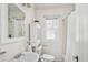 Bright bathroom featuring a vintage style cabinet, window, and shower with white tile at 1615 Locust St, Denver, CO 80220