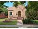 Charming brick home featuring an arched doorway, beautiful tile roof, and manicured front yard at 1615 Locust St, Denver, CO 80220