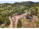 Breathtaking aerial view of a mountain home surrounded by lush greenery and scenic landscapes at 6094 Pyrenees Trl, Golden, CO 80403