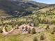 Breathtaking aerial view showcasing a home nestled among lush greenery and mountainous terrain at 6094 Pyrenees Trl, Golden, CO 80403