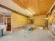 Interior view of barn, highlighting open space and functional storage, featuring wood ceiling and walls at 6094 Pyrenees Trl, Golden, CO 80403