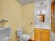 Bright bathroom featuring a vanity, toilet, and urinal, offering functionality and comfort at 6094 Pyrenees Trl, Golden, CO 80403