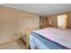 Bedroom features a cozy bed with a vanity and sink view, with hardwood floors that add warmth at 6094 Pyrenees Trl, Golden, CO 80403