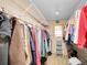 Walk-in closet with organized hanging racks, shelving, and a ladder for accessing higher storage at 6094 Pyrenees Trl, Golden, CO 80403