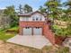 The exterior showcases a two-car garage made of brick in this picturesque mountain home at 6094 Pyrenees Trl, Golden, CO 80403