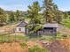 Exterior of a mountain home with metal roof and fenced in yard at 6094 Pyrenees Trl, Golden, CO 80403