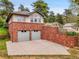 Home with two car garage featuring brick facade and retaining wall. Beautiful mountain views at 6094 Pyrenees Trl, Golden, CO 80403