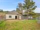 Exterior view of a rustic outbuilding on a fenced property with a mix of natural grass and wooded views at 6094 Pyrenees Trl, Golden, CO 80403