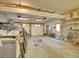 Spacious garage with two garage doors, shelving, and ample room for vehicles and storage at 6094 Pyrenees Trl, Golden, CO 80403