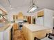 Spacious kitchen with an island, butcher block top, light wood cabinets and slate floors at 6094 Pyrenees Trl, Golden, CO 80403