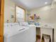 Well-lit laundry room with washer, dryer, and ample storage space at 6094 Pyrenees Trl, Golden, CO 80403