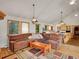 Open-concept living room flows into kitchen, featuring hardwood floors, large sofa and natural light at 6094 Pyrenees Trl, Golden, CO 80403
