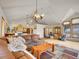 Inviting living space featuring a comfortable sofa, light-filled windows, and views of the kitchen at 6094 Pyrenees Trl, Golden, CO 80403