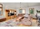 Well-lit living room showcasing comfortable furniture, media center, and hardwood floors at 6094 Pyrenees Trl, Golden, CO 80403