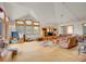 Bright living room with vaulted ceiling, hardwood floors, large windows, and comfortable seating area at 6094 Pyrenees Trl, Golden, CO 80403