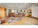 An open-concept living room with a cozy sectional couch, hardwood floors, and natural light at 6094 Pyrenees Trl, Golden, CO 80403