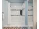 Bathroom with shower/tub, patterned tile, and white fixtures at 2103 Ranch Dr, Westminster, CO 80234