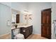 Bathroom features a toilet, vanity, and a large mirror at 2103 Ranch Dr, Westminster, CO 80234